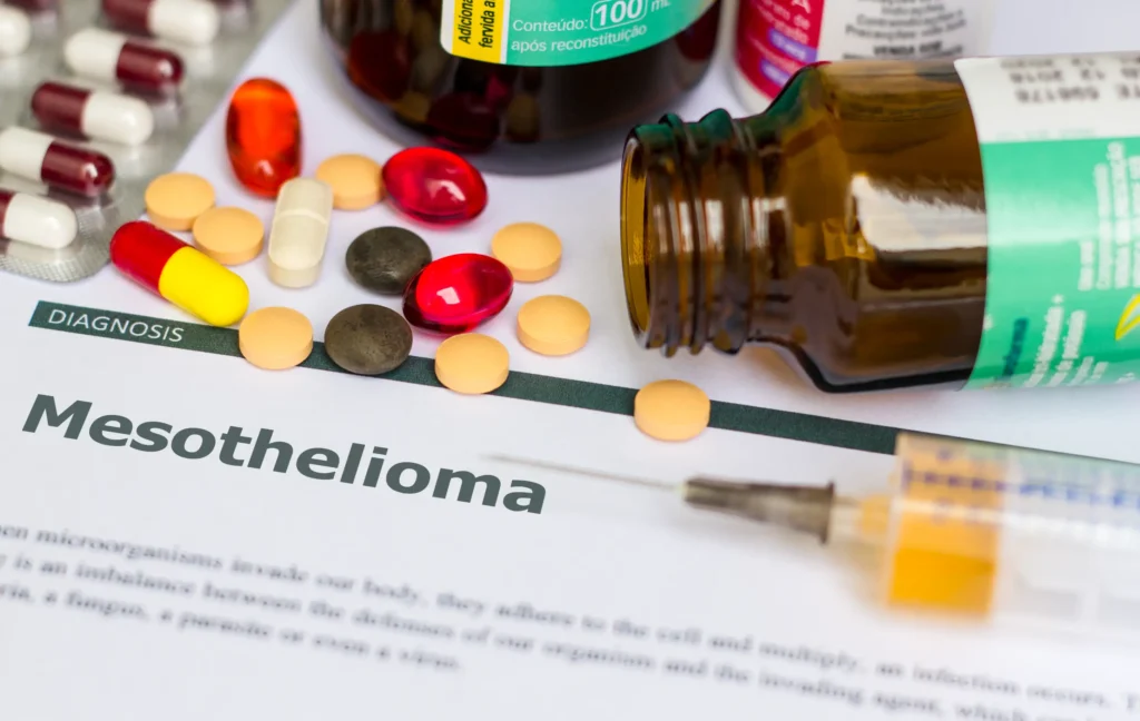 Paperwork that says Mesothelioma with pills, needles on top.