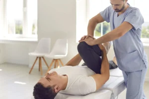 A man receiving physical therapy after an orthopedic injury.